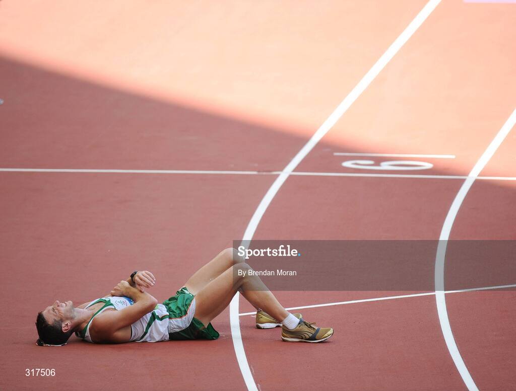 22 August 2008; Jamie Costin, 2047, Ireland, lies on the track after the Men's 50km Walk Final, where he finished 44th in a time of 4:15.16. Beijing 2008 - Games of the XXIX Olympiad, National Stadium, Olympic Green, Beijing, China. Picture credit: Brendan Moran / SPORTSFILE