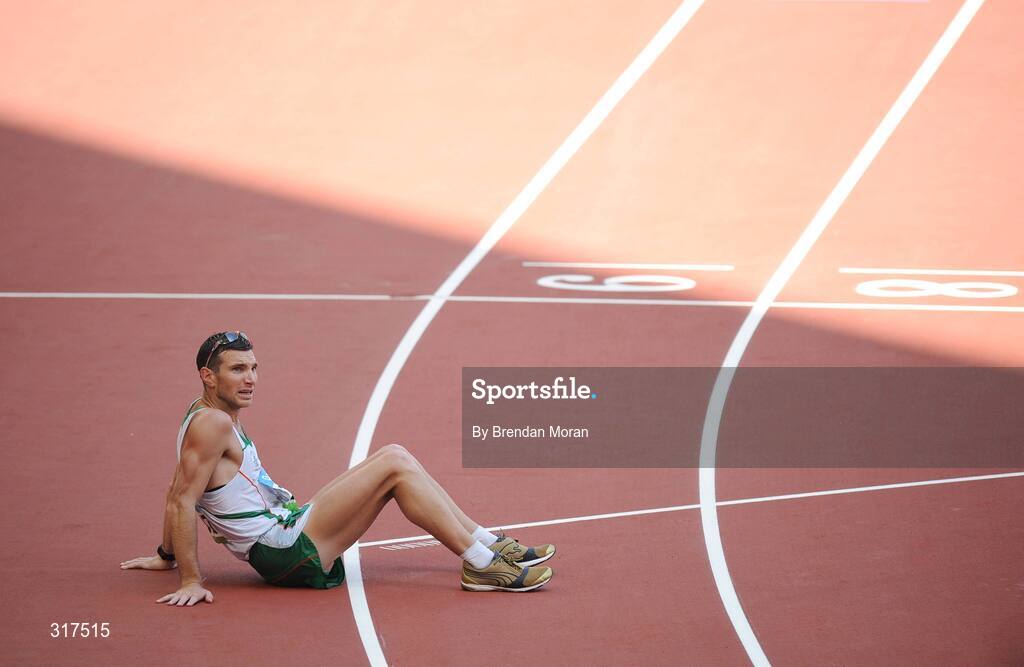 22 August 2008; Jamie Costin, 2047, Ireland, sits on the track after the Men's 50km Walk Final, where he finished 44th in a time of 4:15.16. Beijing 2008 - Games of the XXIX Olympiad, National Stadium, Olympic Green, Beijing, China. Picture credit: Brendan Moran / SPORTSFILE