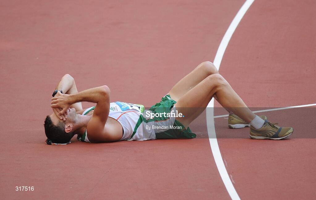 22 August 2008; Jamie Costin, 2047, Ireland, lies on the track after the Men's 50km Walk Final, where he finished 44th in a time of 4:15.16. Beijing 2008 - Games of the XXIX Olympiad, National Stadium, Olympic Green, Beijing, China. Picture credit: Brendan Moran / SPORTSFILE