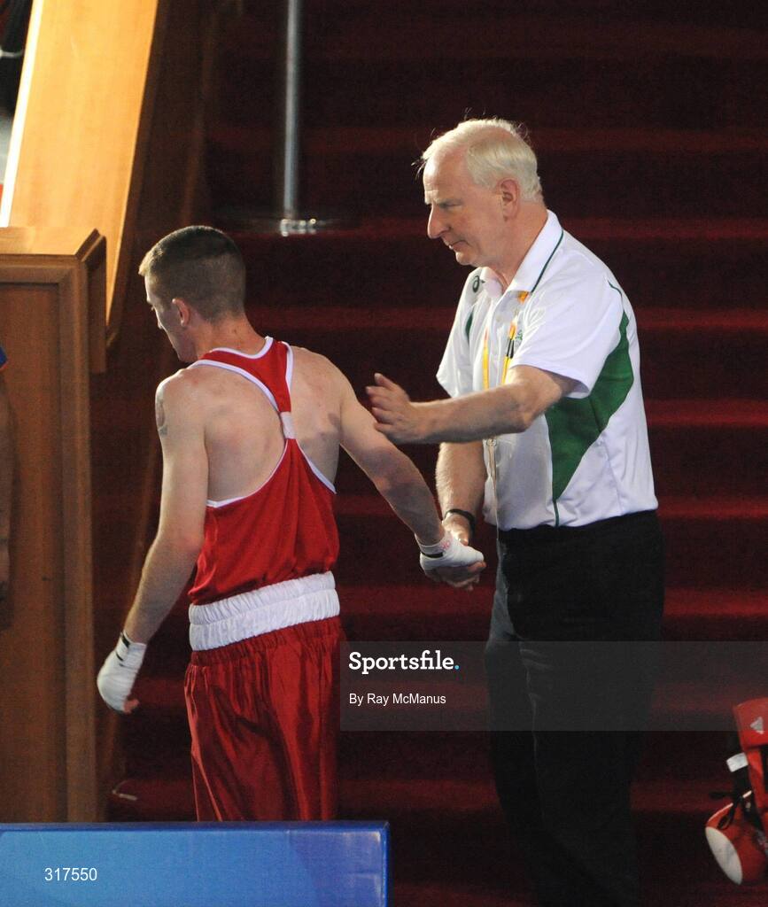 22 August 2008; Patrick Hickey, President of the OCI and President of the EOC commiserates with Paddy Barnes, Ireland, after his defeat to Shiming Zou, from China, in their semi-final bout in the Light Fly weight, 48kg, contest. Beijing 2008 - Games of the XXIX Olympiad, Beijing Workers Gymnasium, Olympic Green, Beijing, China. Picture credit: Ray McManus / SPORTSFILE