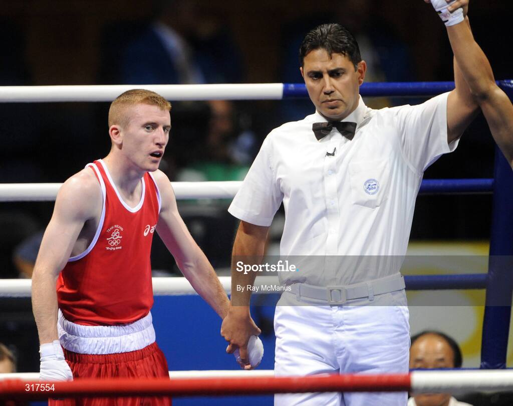 22 August 2008; Paddy Barnes, Ireland, shows his disappointment as the referee raises Shiming Zou's, China, arm in victory after their semi-final bout in the Light Fly weight, 48kg, contest. Beijing 2008 - Games of the XXIX Olympiad, Beijing Workers Gymnasium, Olympic Green, Beijing, China. Picture credit: Ray McManus / SPORTSFILE