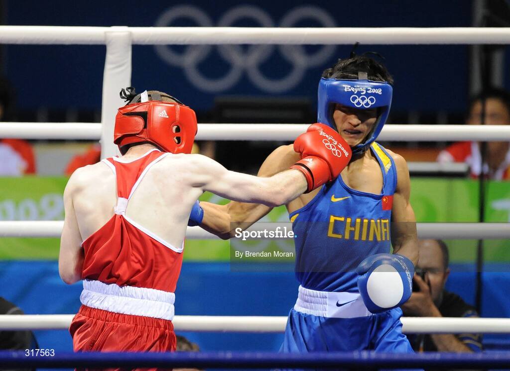22 August 2008; Paddy Barnes, Ireland, lands a punch on Zou Sheming, in blue, China, but no point was awarded by the judges, during the first round of their semi-final bout in the Light Fly weight, 48kg, contest. Beijing 2008 - Games of the XXIX Olympiad, Beijing Workers' Gymnasium, Olympic Green, Beijing, China. Picture credit: Brendan Moran / SPORTSFILE