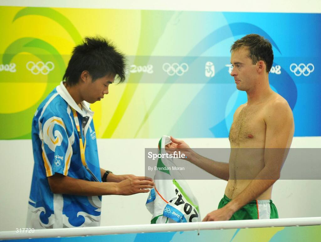 23 August 2008; Alistair Cragg, Ireland, hands his singlet to an official after the Men's 5000m Final, which he failed to finish. Beijing 2008 - Games of the XXIX Olympiad, National Stadium, Olympic Green, Beijing, China. Picture credit: Brendan Moran / SPORTSFILE