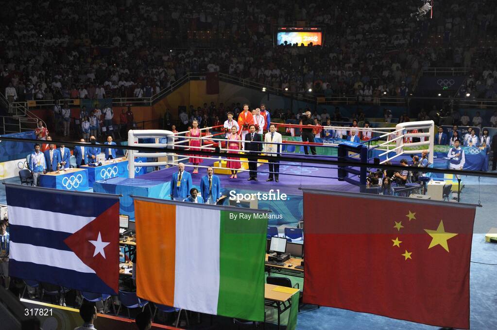 24 August 2008; Gold medal winner, Shiming Zou, China, silver medal winner, Serdamba Purecdorj, Mongolia, left, bronze medal winners, Paddy Barnes, Ireland and Yampier Hernandez, Cuba, stand for the National Anthem of China, after the presentation of medals in the Light Fly weight, 48kg, category. Beijing 2008 - Games of the XXIX Olympiad, Beijing Workers' Gymnasium, Olympic Green, Beijing, China. Picture credit: Ray McManus / SPORTSFILE