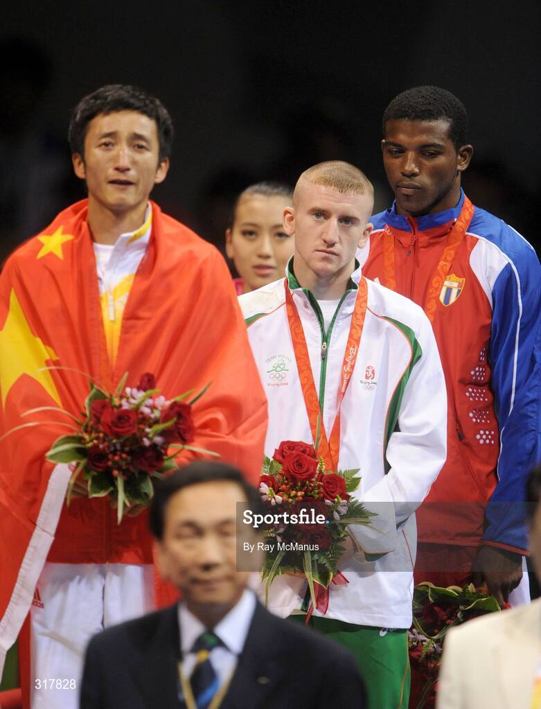 24 August 2008; Gold medal winner, Shiming Zou, China, left, bronze medal winner, Paddy Barnes, Ireland and Yampier Hernandez, Cuba, stand for the National Anthem of China after the presentation of medals in the Light Fly weight, 48kg, category. Beijing 2008 - Games of the XXIX Olympiad, Beijing Workers' Gymnasium, Olympic Green, Beijing, China. Picture credit: Ray McManus / SPORTSFILE