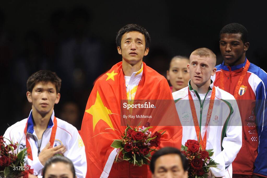 24 August 2008; Gold medal winner, Shiming Zou, China, silver medal winner, Serdamba Purecdorj, Mongolia, left, bronze medal winners, Paddy Barnes, Ireland, and Yampier Hernandez, Cuba, stand for the National Anthem of China, after the presentation of medals in the Light Fly weight, 48kg, category. Beijing 2008 - Games of the XXIX Olympiad, Beijing Workers' Gymnasium, Olympic Green, Beijing, China. Picture credit: Ray McManus / SPORTSFILE