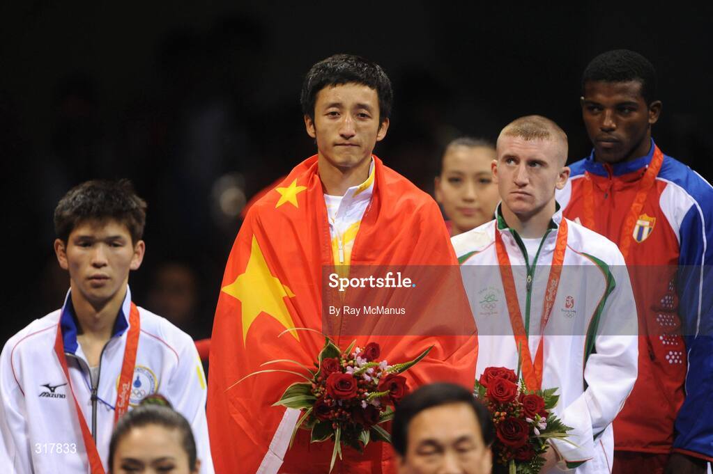 24 August 2008; Gold medal winner, Shiming Zou, China, silver medal winner, Serdamba Purecdorj, Mongolia, left, bronze medal winners, Paddy Barnes, Ireland, and Yampier Hernandez, Cuba, stand for the National Anthem of China, after the presentation of medals in the Light Fly weight, 48kg, category. Beijing 2008 - Games of the XXIX Olympiad, Beijing Workers' Gymnasium, Olympic Green, Beijing, China. Picture credit: Ray McManus / SPORTSFILE