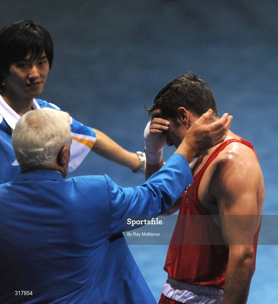 24 August 2008; Kenneth Egan, Ireland, is consoled by officials after his bout with Xiaoping Zhang, China, in the Light Heavy weight Final, 81kg, contest. Beijing 2008 - Games of the XXIX Olympiad, Beijing Workers' Gymnasium, Olympic Green, Beijing, China. Picture credit: Ray McManus / SPORTSFILE