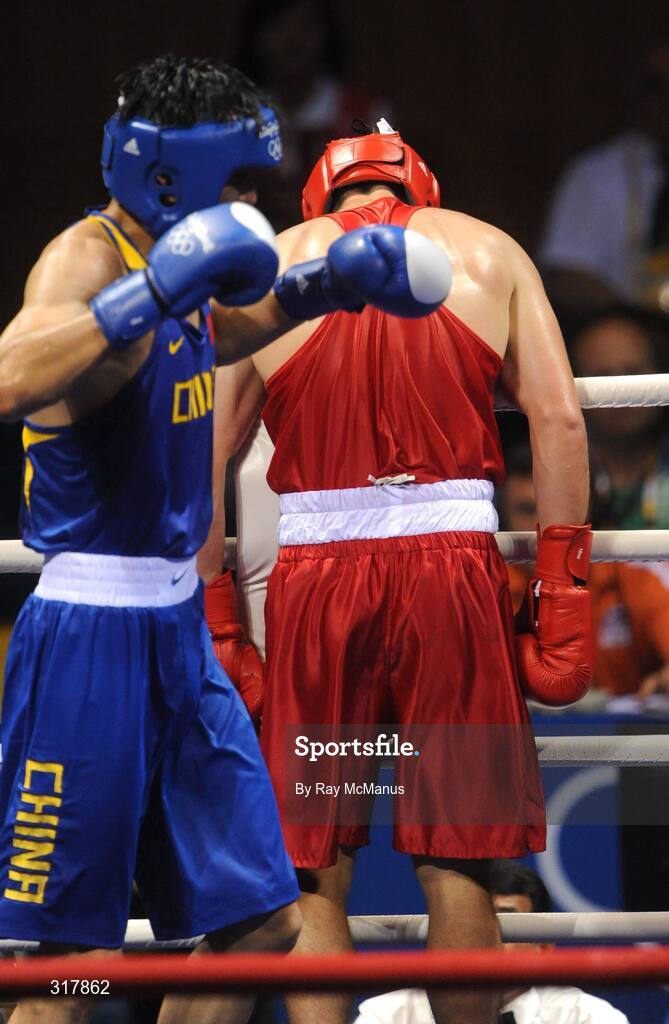 24 August 2008; Kenneth Egan, Ireland, slumps over the ring as the final bell rings while his opponent Xiaoping Zhang, China, begins the celebrations after the Light Heavy weight Final, 81kg, contest. Beijing 2008 - Games of the XXIX Olympiad, Beijing Workers' Gymnasium, Olympic Green, Beijing, China. Picture credit: Ray McManus / SPORTSFILE