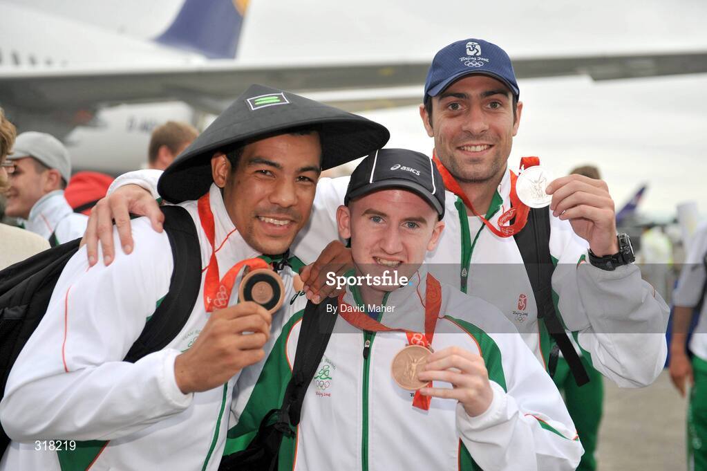 26 August 2008; The Irish Olympic Team, including silver medallist Kenny Egan, left, bronze medallist Darren Sutherland, right, and bronze medallist Paddy Barnes, arrive at Dublin Airport, Dublin. Picture credit: David Maher / SPORTSFILE