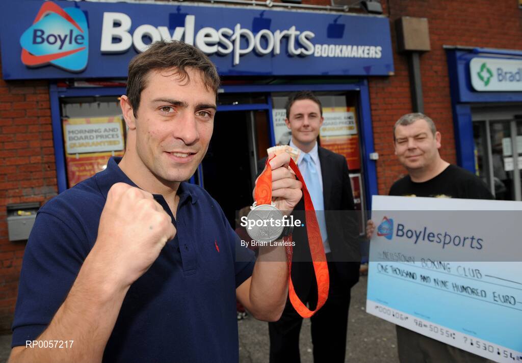 29 August 2008; Olympic boxing silver medalist Kenny Egan, left, with Leon Blanche from Boylesports, centre, and Gerard Flemming, Kenny's coach in Neilstown Boxing Club, at the Boylesports shop in Neilstown. Kenny collected his winnings after he placed a bet on himself to win a medal in Beijing. Boylesports generously trebled his winnings and gave the same amount to Kenny’s club in Neilstown to prepare the boxers of the future. Boylseports, Clondalkin, Dublin. Picture credit: Brian Lawless / SPORTSFILE