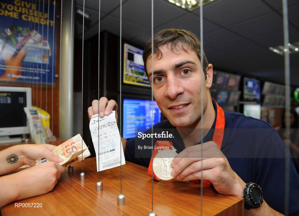 29 August 2008; Olympic boxing silver medalist Kenny Egan collects his winnings at the Boylesports shop in Neilstown. Kenny collected his winnings after he placed a bet on himself to win a medal in Beijing. Boylesports generously trebled his winnings and gave the same amount to Kenny’s club in Neilstown to prepare the boxers of the future. Boylseports, Clondalkin, Dublin. Picture credit: Brian Lawless / SPORTSFILE