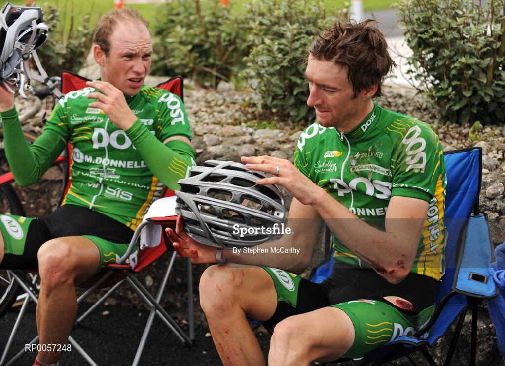 29 August 2008; Daniel Lloyd, of the An Post sponsored Sean Kelly team, examines his helmet with team-mate Benny de Schrooder after falling towards the end of the stage. 2008 Tour of Ireland - Stage 3, Ballinrobe - Galway. Picture credit: Stephen McCarthy / SPORTSFILE  *** Local Caption ***