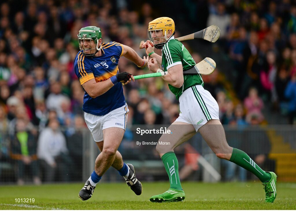 21 June 2015; John O'Dwyer, Tipperary, is restrained by Seamus Hickey, Limerick, as they watch a loose ball. Munster GAA Hurling Senior Championship, Semi-Final, Limerick v Tipperary, Gaelic Grounds, Limerick. Picture credit: Brendan Moran / SPORTSFILE