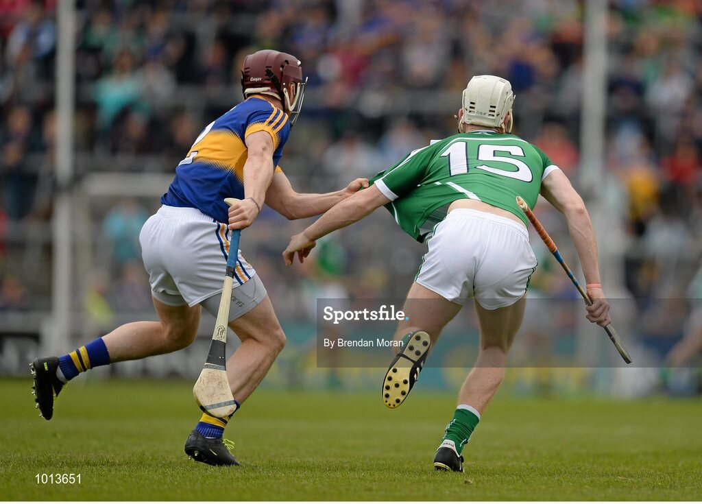 21 June 2015; Paddy Stapleton, Tipperary, holds onto the jersey of Cian Lynch, Limerick, for which he was subsequently shown a yellow card. Munster GAA Hurling Senior Championship, Semi-Final, Limerick v Tipperary, Gaelic Grounds, Limerick. Picture credit: Brendan Moran / SPORTSFILE