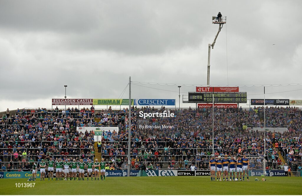 21 June 2015; The teams and match officials stand during a minute's silence in memory of the those who died and were injured in the 'Berkeley' tragedy. Munster GAA Hurling Senior Championship, Semi-Final, Limerick v Tipperary, Gaelic Grounds, Limerick. Picture credit: Brendan Moran / SPORTSFILE
