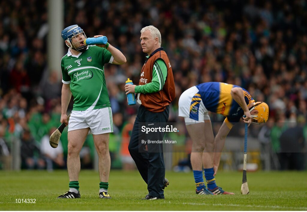 21 June 2015; Member of the Limerick backroom team Conor McCarthy gives water to Richie McCarthy during the game. Munster GAA Hurling Senior Championship, Semi-Final, Limerick v Tipperary, Gaelic Grounds, Limerick. Picture credit: Brendan Moran / SPORTSFILE