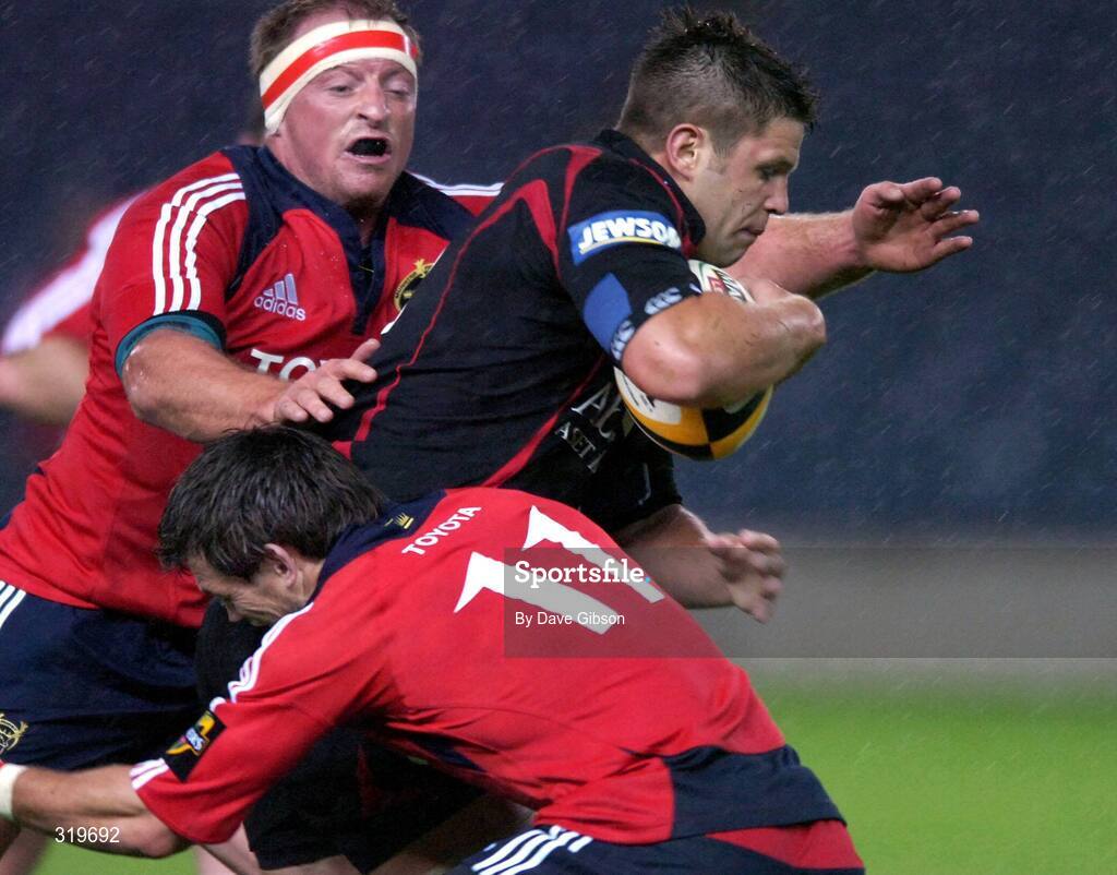 5 September 2008; Ally Hogg, Edinburgh, is tackled by Ian Dowling and Mick O'Driscoll, left, Munster. Magners League, Edinburgh v Munster, Murrayfield Stadium, Edinburgh, Scotland. Picture credit: Dave Gibson / SPORTSFILE