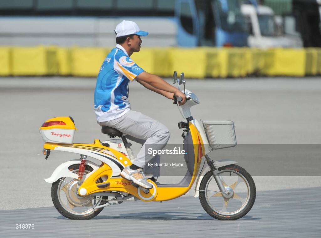 2 August 2008; A volunteer drives around on a bike as preparations continue ahead of the opening ceremony on Friday next, 8th of August. Beijing 2008 - Games of the XXIX Olympiad, Olympic Green, Beijing, China. Picture credit: Brendan Moran / SPORTSFILE