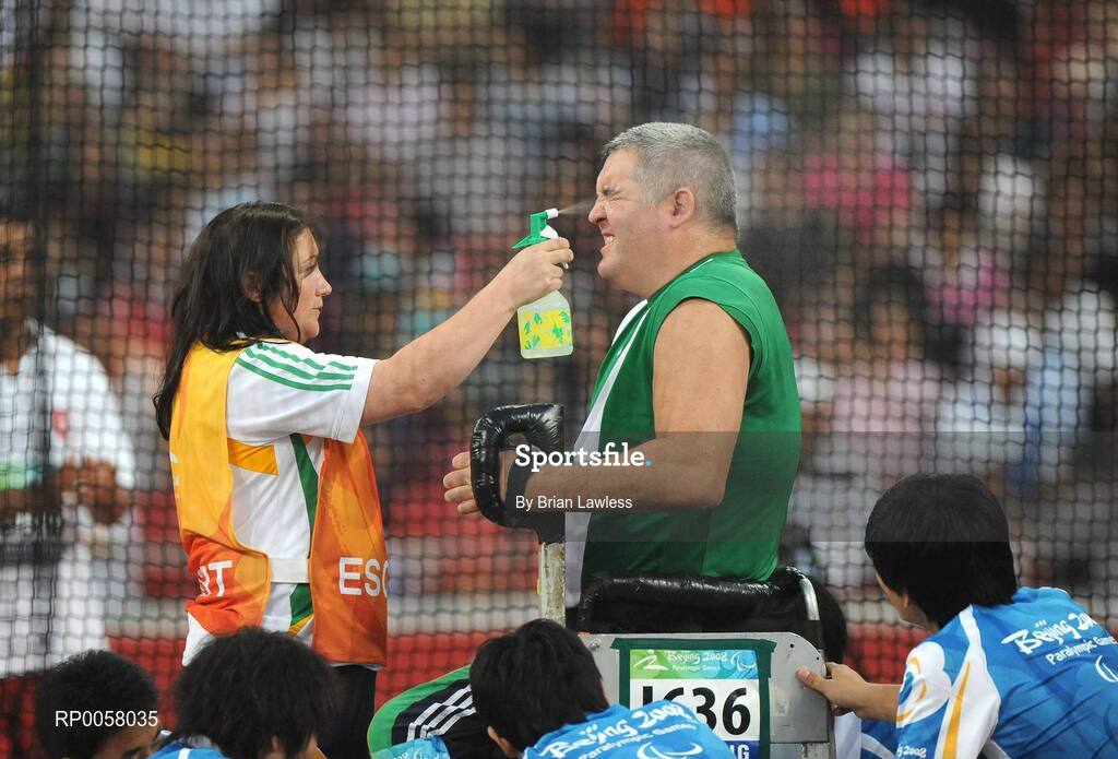 8 September 2008; Garrett Culliton, from Clonaslee, Co. Laois, receives assistance from Rose McCoy, from Knockabbey, Louth, during the Men's Discus Throw - F33/34/52 Final. Garrett finished in 5th position overall with a distance of 17.79m setting a new Irish record. Beijing Paralympic Games 2008, Men's Shot Putt Final F32, National Stadium, Olympic Green, Beijing, China. Picture credit: Brian Lawless / SPORTSFILE