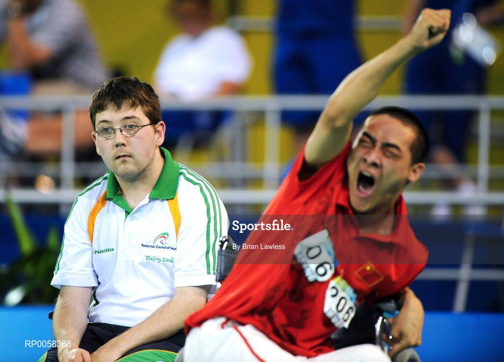 11 September 2008; Ireland's Padraic Moran, from Bray, Wicklow, looks on as China's Zhiqiang Yan celebrates a point during the Mixed Team BC1-2 Quarter Final match. The Irish team exited the tournament at the hands of the Chinese with a final score of 12-2. Beijing Paralympic Games 2008, Mixed Team BC1-2,  Quarter Final, Ireland v China, Fencing Hall of National Convention Centre, Olympic Green, Beijing, China. Picture credit: Brian Lawless / SPORTSFILE