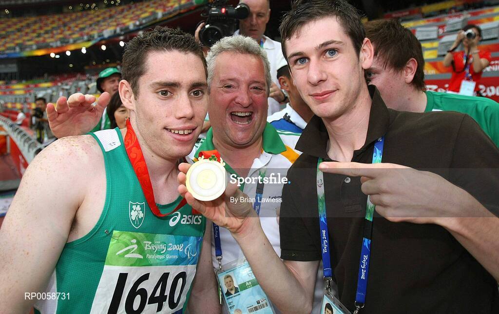 13 September 2008; Ireland's Jason Smyth, from Eglinton, Co. Derry, left, celebrates with Coach Stephen Maguire, from Strabane, Tyrone, centre, and 800m Gold medalist Michael McKillop, from Glengormley, Antrim, after winning the Men's 100m T13 Final to win Gold and setting a new world and paralympic record in a time of 10.62, beating his own world record of 10.81 which he set in this morning's heats. Beijing Paralympic Games 2008, Men's 100m T13 Final, National Stadium, Olympic Green, Beijing, China. Picture credit: Brian Lawless / SPORTSFILE