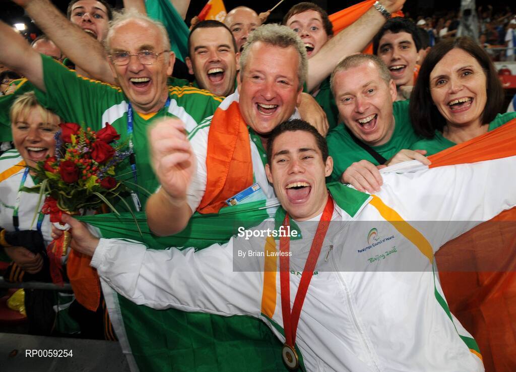 16 September 2008; Ireland's Jason Smyth, from Eglinton, Co. Derry, celebrates with from left, Assistant Paralympic Performance Director Nancy Chillingworth, 800m T37 gold medalist Michael McKillop, Chef de Mission Jimmy Byrne, Paralympic Performance Director, Liam Harbison, Team Physiologist Bruce Wardrop, Ambulant Track Coach Stephen Maguire, Ben Kilgore, Smyth's father Lloyd, brother Justyn and mother Diane after the Men's 200m -T13 Final. Smyth won his second gold of these Paralympic games in a World record time of 21.43 seconds, his first coming in the Men's 100m T13 Final also in a world record time of 10.62. Beijing Paralympic Games 2008, Men's 200m -T13, Final, National Stadium, Olympic Green, Beijing, China. Picture credit: Brian Lawless / SPORTSFILE