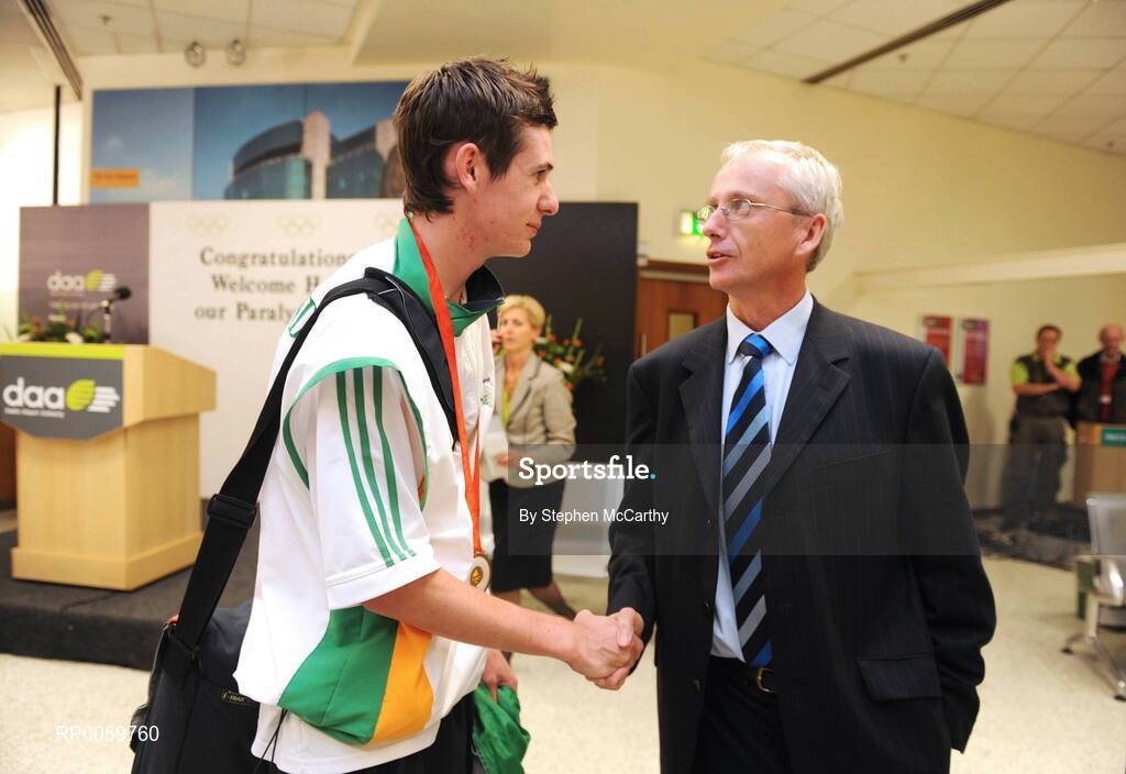 19 September 2008; Michael McKillop, from Glengormley, Co. Antrim, who won a gold medal in the Men's 800m - T37, is greeted by John Tracey, Irish Sports Council, at Dublin Airport as the Irish Paralympic Team arrived home from Beijing. Dublin Airport, Dublin. Picture credit: Stephen McCarthy / SPORTSFILE