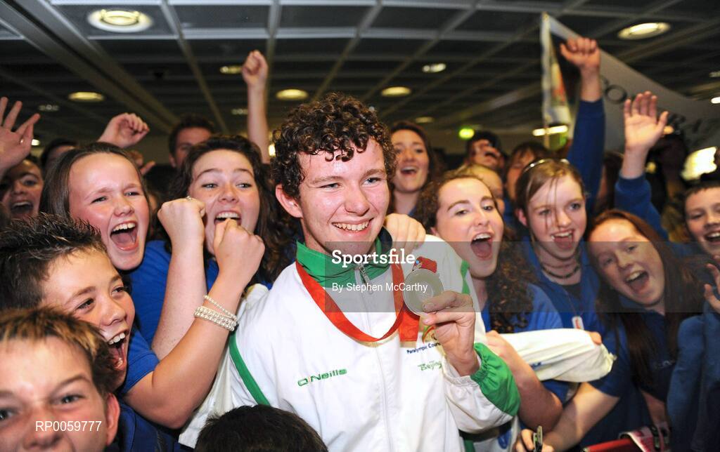 19 September 2008; Darragh McDonald, from Gorey, Co. Wexford, who won a silver medal in the Men's 400m Freestyle - S6 Final, is congratulated by members of his local Asguard Swimming Club, Arklow, at Dublin Airport as the Irish Paralympic Team arrived home from Beijing. Dublin Airport, Dublin. Picture credit: Stephen McCarthy / SPORTSFILE