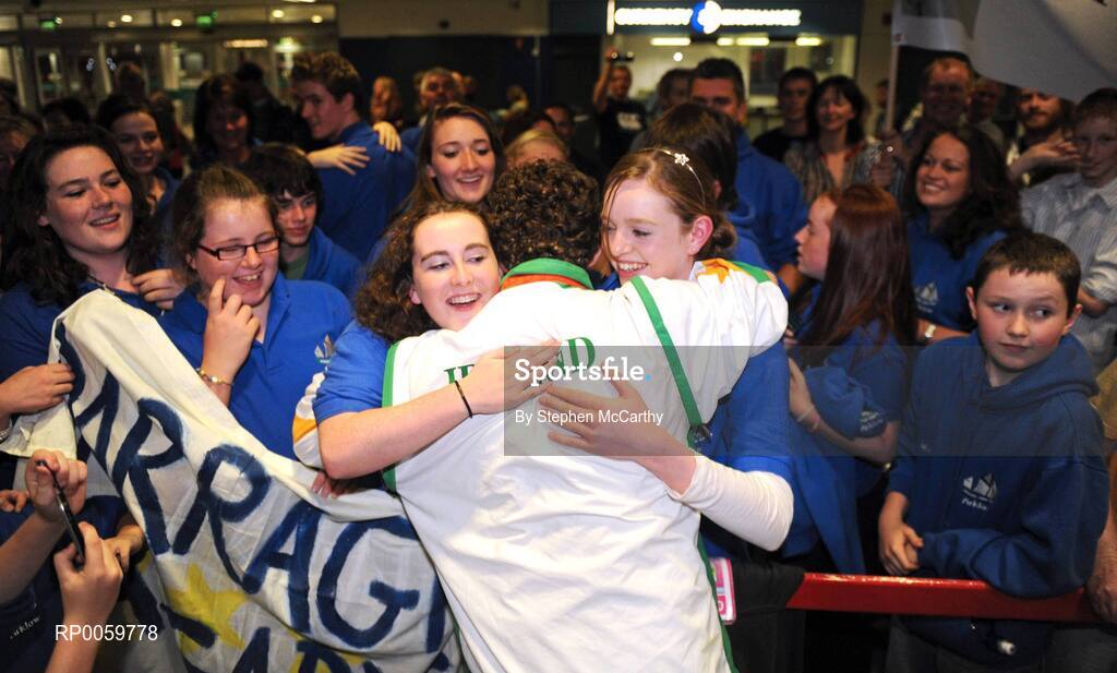 19 September 2008; Darragh McDonald, from Gorey, Co. Wexford, who won a silver medal in the Men's 400m Freestyle - S6 Final, is congratulated by members of his local Asguard Swimming Club, Arklow, at Dublin Airport as the Irish Paralympic Team arrived home from Beijing. Dublin Airport, Dublin. Picture credit: Stephen McCarthy / SPORTSFILE