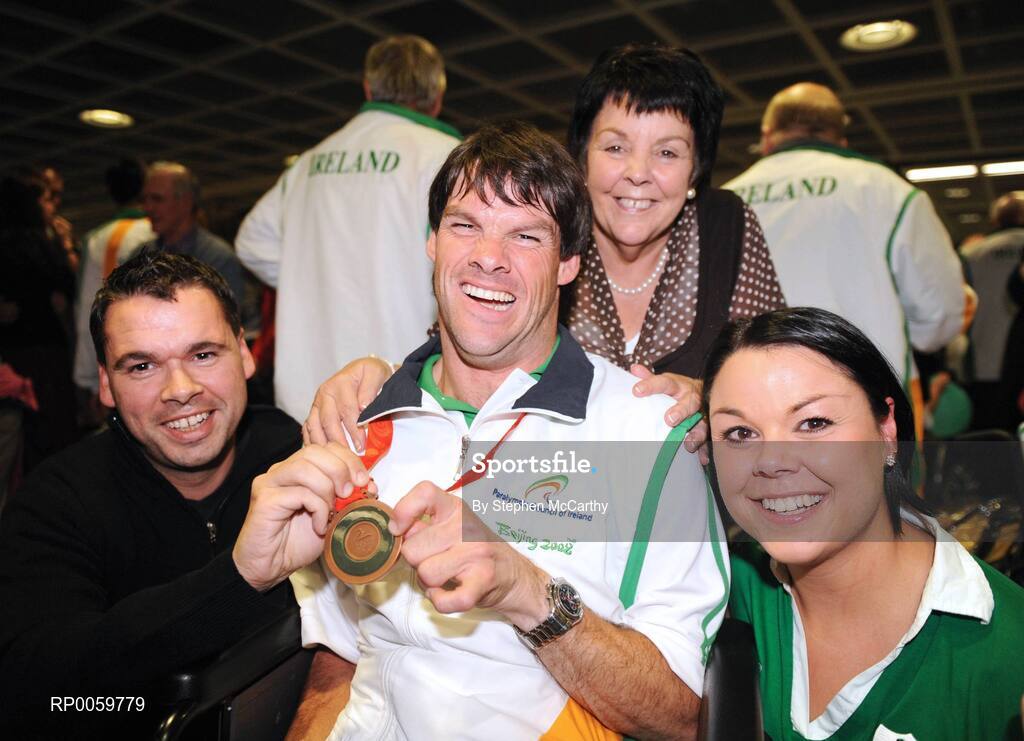 19 September 2008; Gabriel Shelly, from Bagenalstown, Co. Carlow, who won a bronze medal in the Boccia Mixed Individual - BC1, celebrates with brother Eamon, mother Pat and sister Toni at Dublin Airport as the Irish Paralympic Team arrived home from Beijing. Dublin Airport, Dublin. Picture credit: Stephen McCarthy / SPORTSFILE