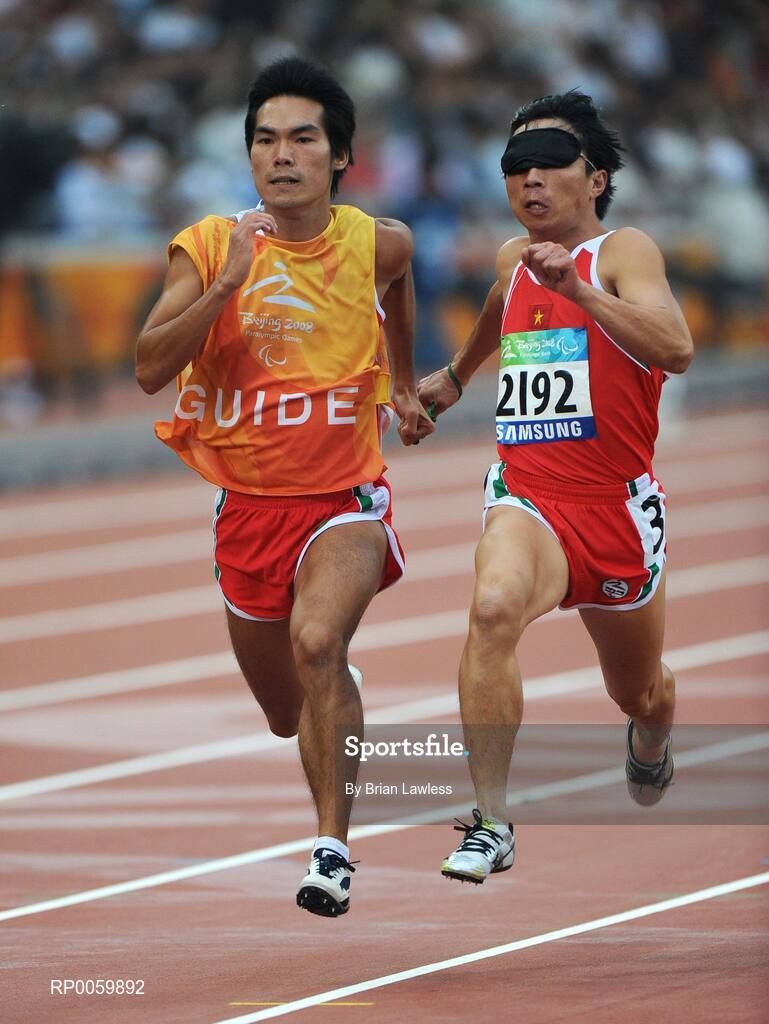 8 September 2008;  Vietnam's Cuong van Dao, runs with his guide during the Men's 100m - T11 Round 1 Heat 2. Beijing Paralympic Games 2008, Men's 100m - T11 Round 1 Heat 2, National Stadium, Olympic Green, Beijing, China. Picture credit: Brian Lawless / SPORTSFILE
