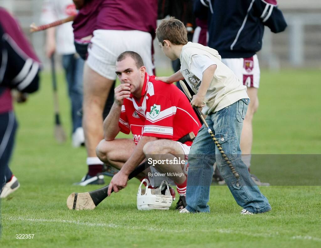 28 September 2008; A young fan consoles Johnny Campbell, Loughgiel Shamrocks, after the game. Antrim County Senior Hurling Final, Cushendalls Ruairi Og's v Loughgiel Shamrocks, Casement Park, Belfast, Co. Antrim. Picture credit: Oliver McVeigh / SPORTSFILE