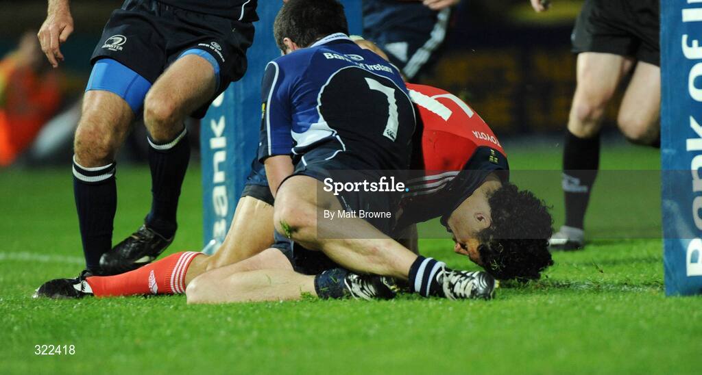 28 September 2008; Doug Howlett, Munster, goes over for the second try against Leinster despite the tackle of Shane Jennings. Magners League, Leinster v Munster, RDS, Dublin. Picture credit: Matt Browne / SPORTSFILE