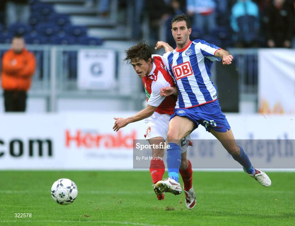 30 September 2008; Ryan Guy, St. Patrick's Athletic, gets his shot away despite the challenge of Hertha Berlin's Maximilian Nicu. UEFA Cup First Round 2nd leg, St. Patrick's Athletic v Hertha Berlin, RDS, Dublin. Picture credit: Pat Murphy / SPORTSFILE