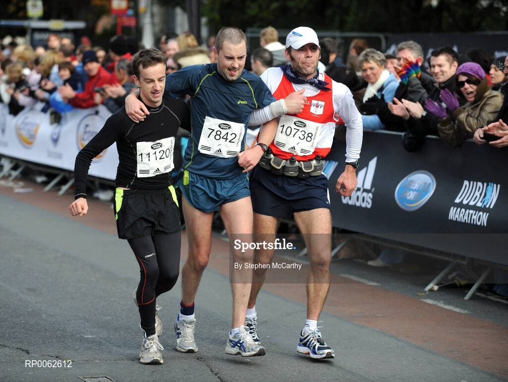 27 October 2008; Donal Cashin, from Dublin, is supported by Ronan Moore, from Meath, left, and Robert Gallagher, from Tyrone, on the approach to the finish of the the Lifestyle Sports - adidas Dublin Marathon 2008. Merrion Square, Dublin. Picture credit: Stephen McCarthy / SPORTSFILE