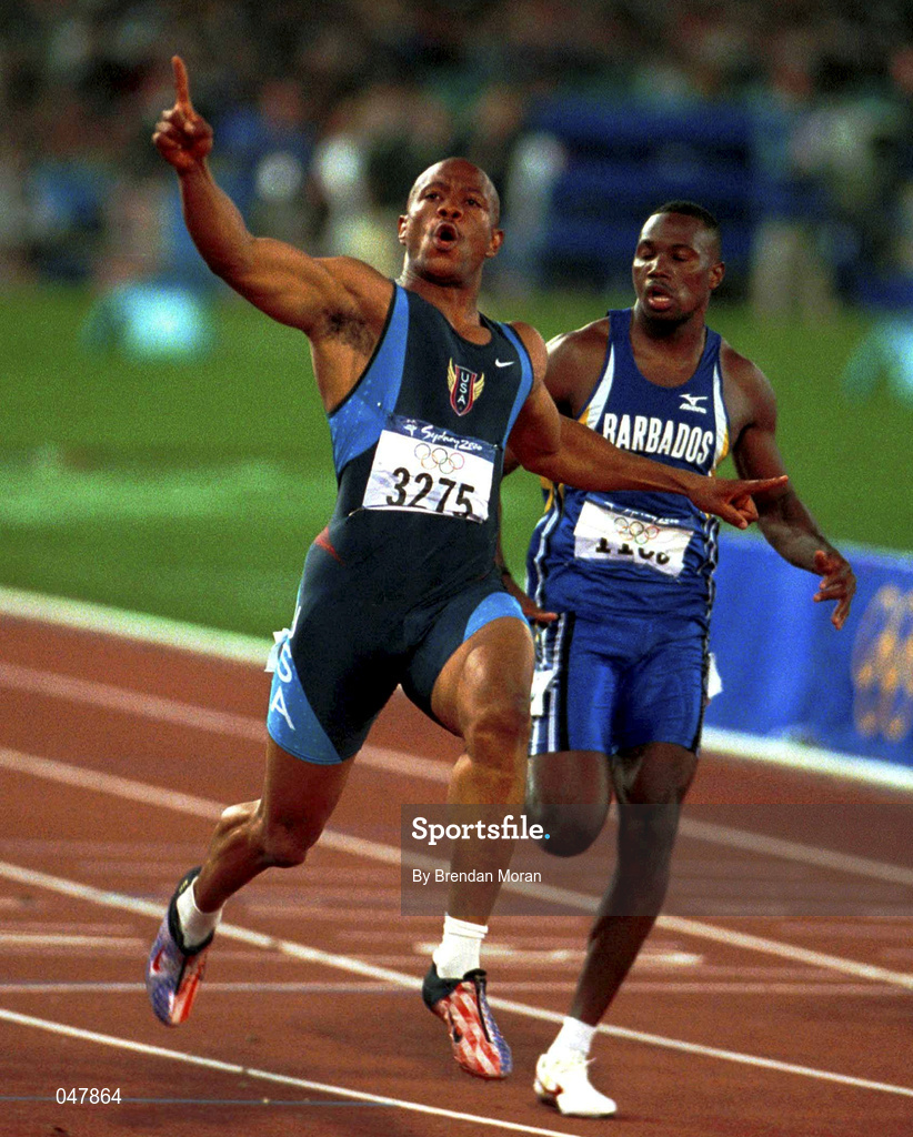 23 September 2000; USA's Maurice Greene celebrates winning Gold ahead of bronze medallist Oabdele Thompson of Barbados in the Men's 100m Final. Stadium Australia, Sydney Olympic Park. Homebush Bay, Sydney, Australia.  Photo by Brendan Moran/Sportsfile