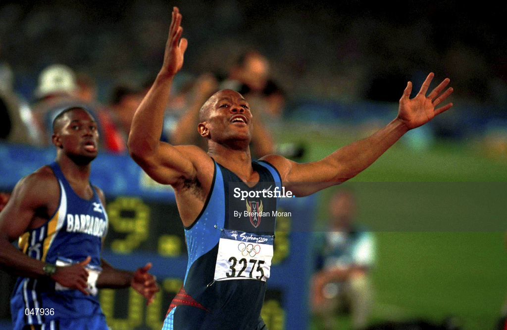 23 September 2000; USA's Maurice Greene celebrates winning Gold ahead of bronze medallist Oabdele Thompson of Barbados in the Men's 100m Final. Stadium Australia, Sydney Olympic Park. Homebush Bay, Sydney, Australia.  Photo by Brendan Moran/Sportsfile