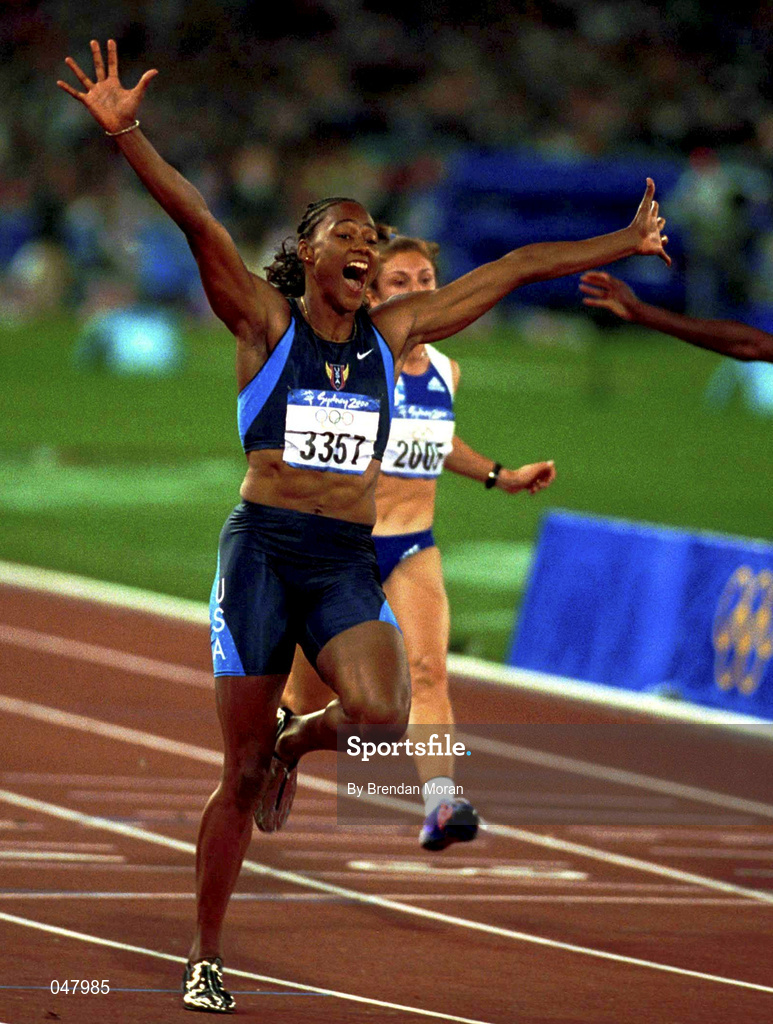 23 September 2000; USA's Marion Jones celebrates winning Gold in the Women's 100m Final. Stadium Australia, Sydney Olympic Park. Homebush Bay, Sydney, Australia.  Photo by Brendan Moran/Sportsfile
