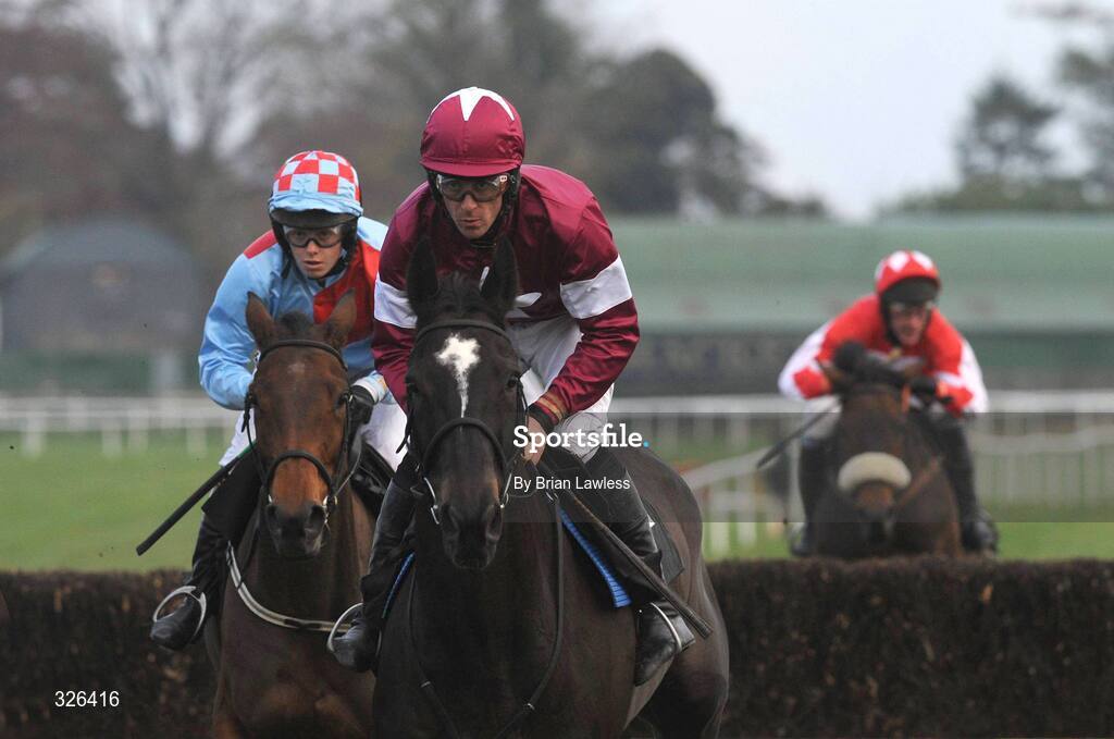 6 November 2008; War of Attrition, with Davy Russell up, on the way to winning the Thurles Steeplechase ahead of second place Carrigeen Kalmia, Miss E.A. Lalor up, left. Thurles Racecourse, Thurles, Co. Tipperary. Picture credit: Brian Lawless / SPORTSFILE