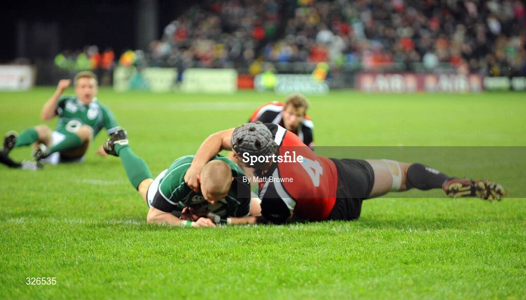 8 November 2008; Ireland's Keith Earls goes over for the first try of the game despite the tackle of Canada's Mike Burak. Guinness Autumn Internationals, Ireland v Canada, Thomond Park, Limerick. Picture credit: Matt Browne / SPORTSFILE