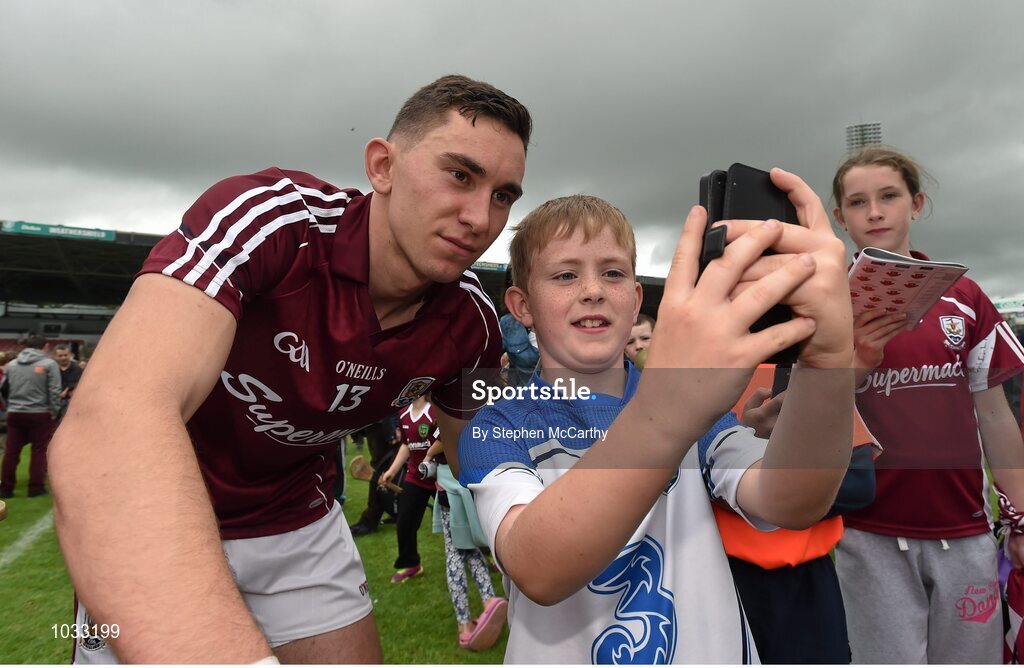26 July 2015; Michael Morrissey, age 10, from Fourmilewater, Waterford, has a picture taken with Jason Flynn, Galway. GAA Hurling All-Ireland Senior Championship, Quarter-Final, Galway v Cork. Semple Stadium, Thurles, Co. Tipperary. Picture credit: Stephen McCarthy / SPORTSFILE