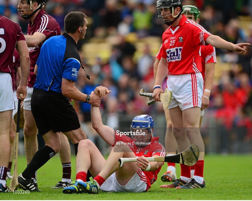 26 July 2015; Cork's Patrick Horgan is helped to his feet by referee James Owens after he was fouled. GAA Hurling All-Ireland Senior Championship, Quarter-Final, Galway v Cork. Semple Stadium, Thurles, Co. Tipperary. Picture credit: Piaras Ó Mídheach / SPORTSFILE