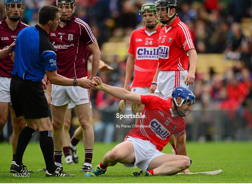 26 July 2015; Cork's Patrick Horgan is helped to his feet by referee James Owens after he was fouled. GAA Hurling All-Ireland Senior Championship, Quarter-Final, Galway v Cork. Semple Stadium, Thurles, Co. Tipperary. Picture credit: Piaras Ó Mídheach / SPORTSFILE