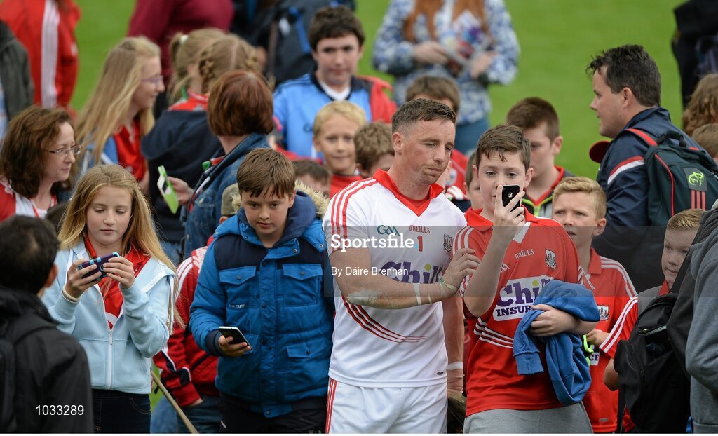 26 July 2015; A dejected Anthony Nash, poses for selfies with supporters on his way off the pitch after the game. GAA Hurling All-Ireland Senior Championship, Quarter-Final, Galway v Cork. Semple Stadium, Thurles, Co. Tipperary. Picture credit: Dáire Brennan / SPORTSFILE