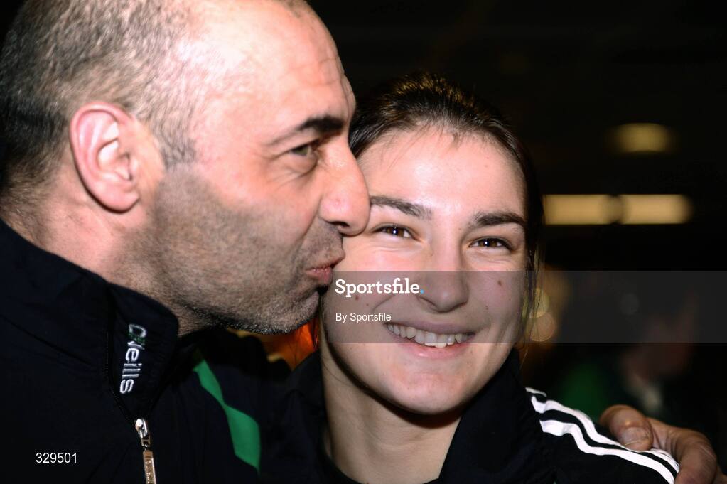 1 December 2008; Ireland's Katie Taylor, who won a gold medal in the 60kg category at the AIBA Women's World Championships in China, gets a kiss from her Dad and trainer Peter at the homecoming in Dublin Airport. Photo by Sportsfile