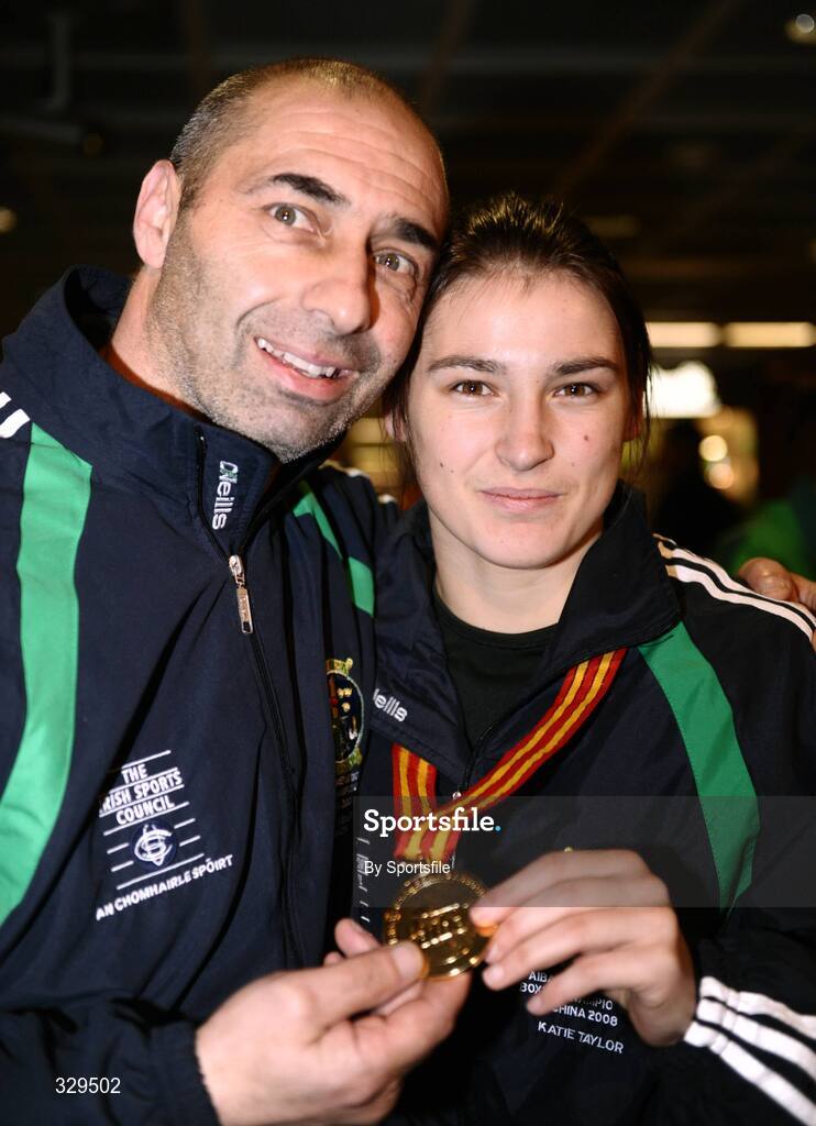 1 December 2008; Ireland's Katie Taylor, who won a gold medal in the 60kg category at the AIBA Women's World Championships in China, with her Dad and trainer Peter at the homecoming in Dublin Airport. Photo by Sportsfile