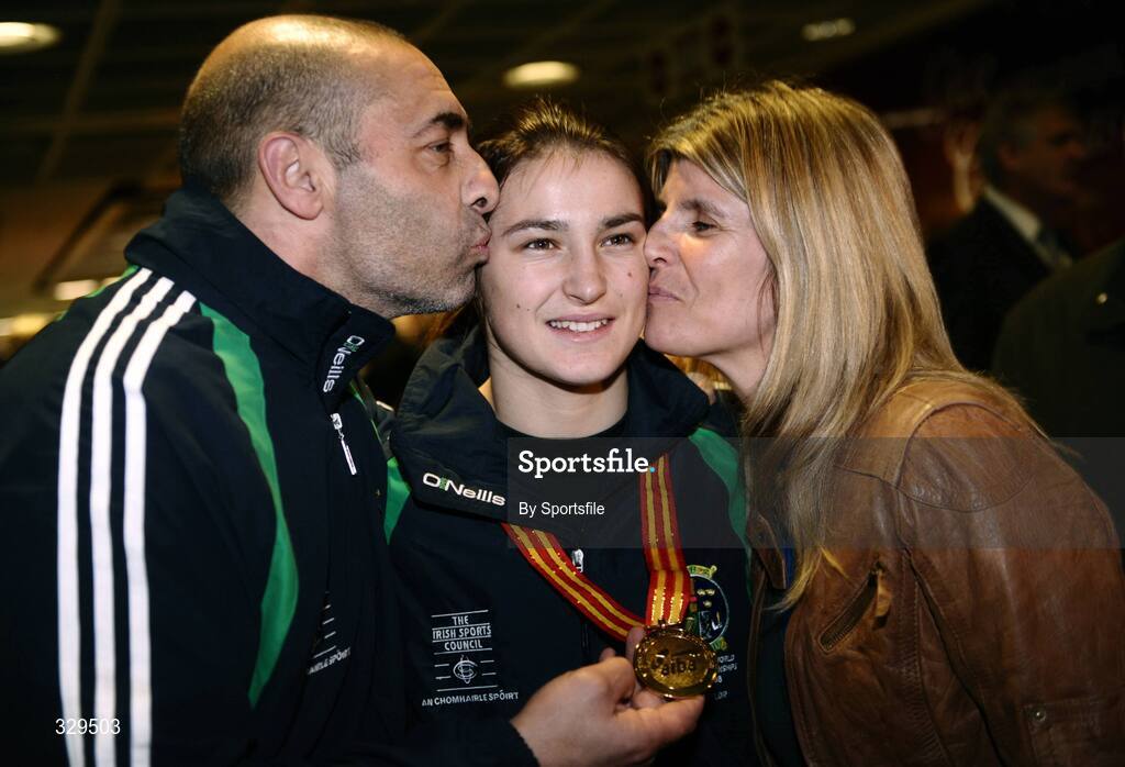 1 December 2008; Ireland's Katie Taylor, who won a gold medal in the 60kg category at the AIBA Women's World Championships in China, gets a kiss from her Dad and trainer Peter and mother Bridget at the homecoming in Dublin Airport. Photo by Sportsfile