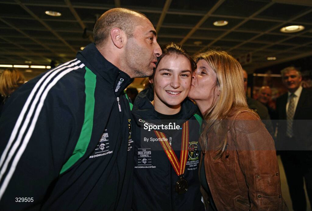 1 December 2008; Ireland's Katie Taylor, who won a gold medal in the 60kg category at the AIBA Women's World Championships in China, gets a kiss from her Dad and trainer Peter and mother Bridget at the homecoming in Dublin Airport. Photo by Sportsfile