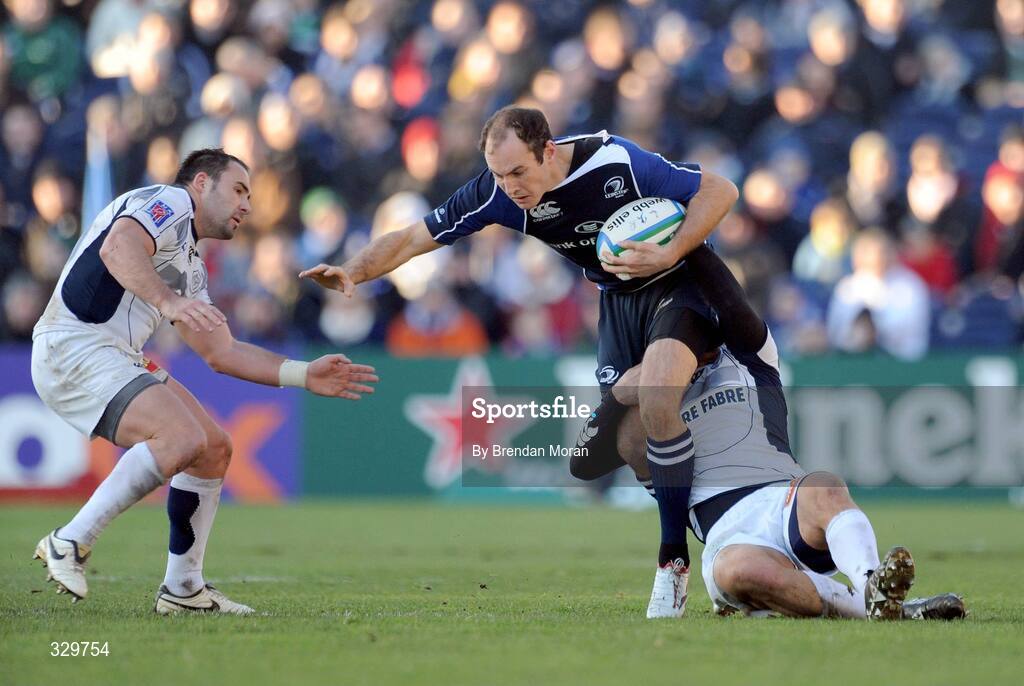 6 December 2008; Girvan Dempsey, Leinster, is tackled by Lionel Mazars and Anthony Lagardere, right, Castres Olympique. Heineken Cup, Pool 2, Round 3, Leinster v Castres Olympique, RDS, Dublin. Picture credit: Brendan Moran / SPORTSFILE